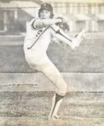 A baseball pitcher in mid-delivery.