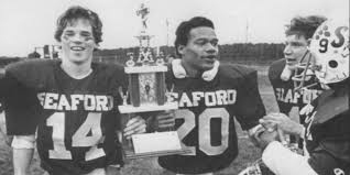 Seaford football players gathered with a trophy.