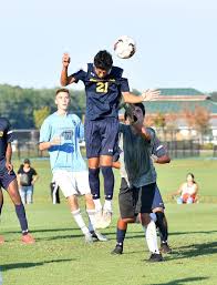 Seaford soccer player leaping to head the ball.