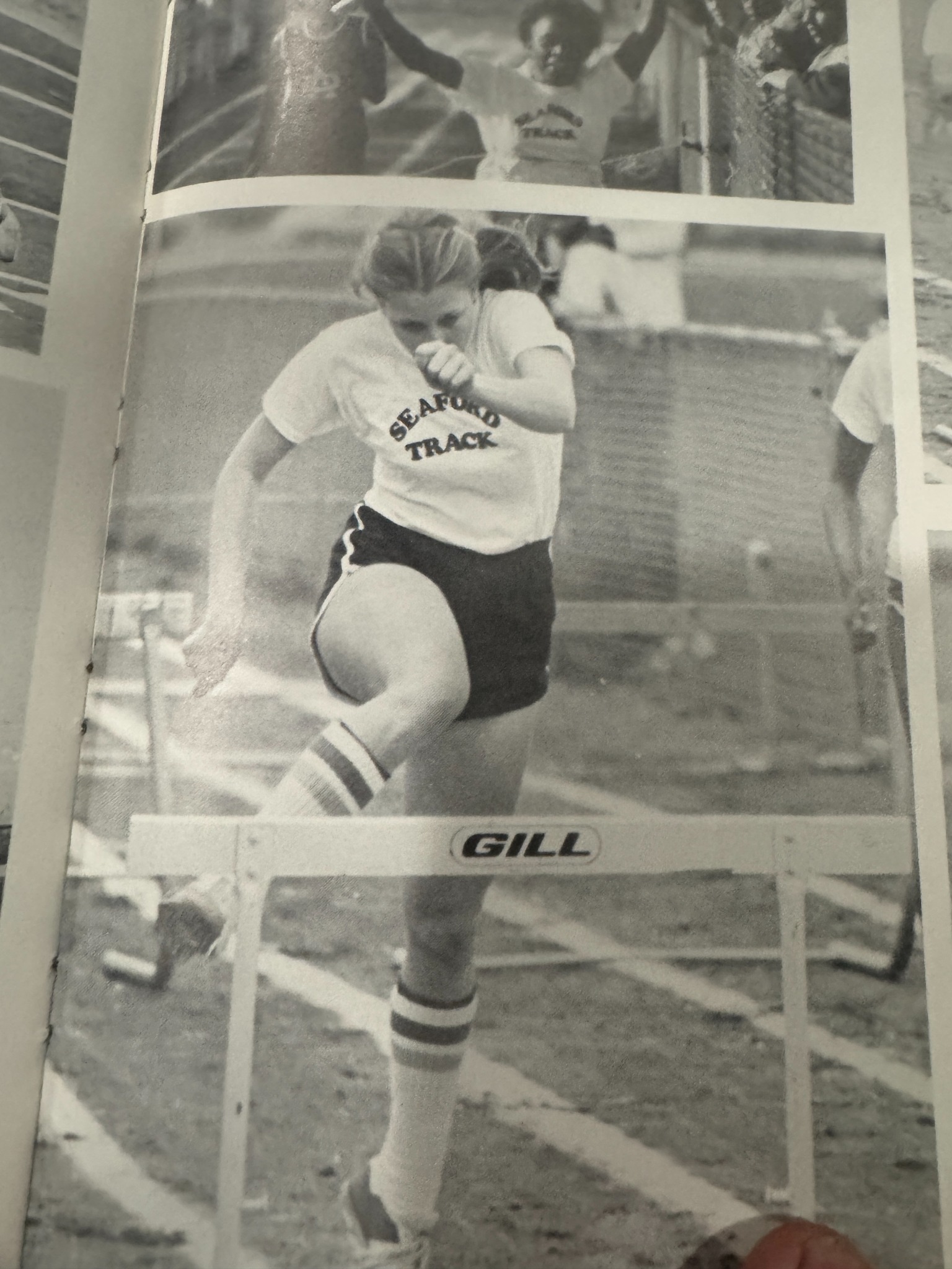 Seaford track athlete clearing a hurdle in a yearbook photograph.