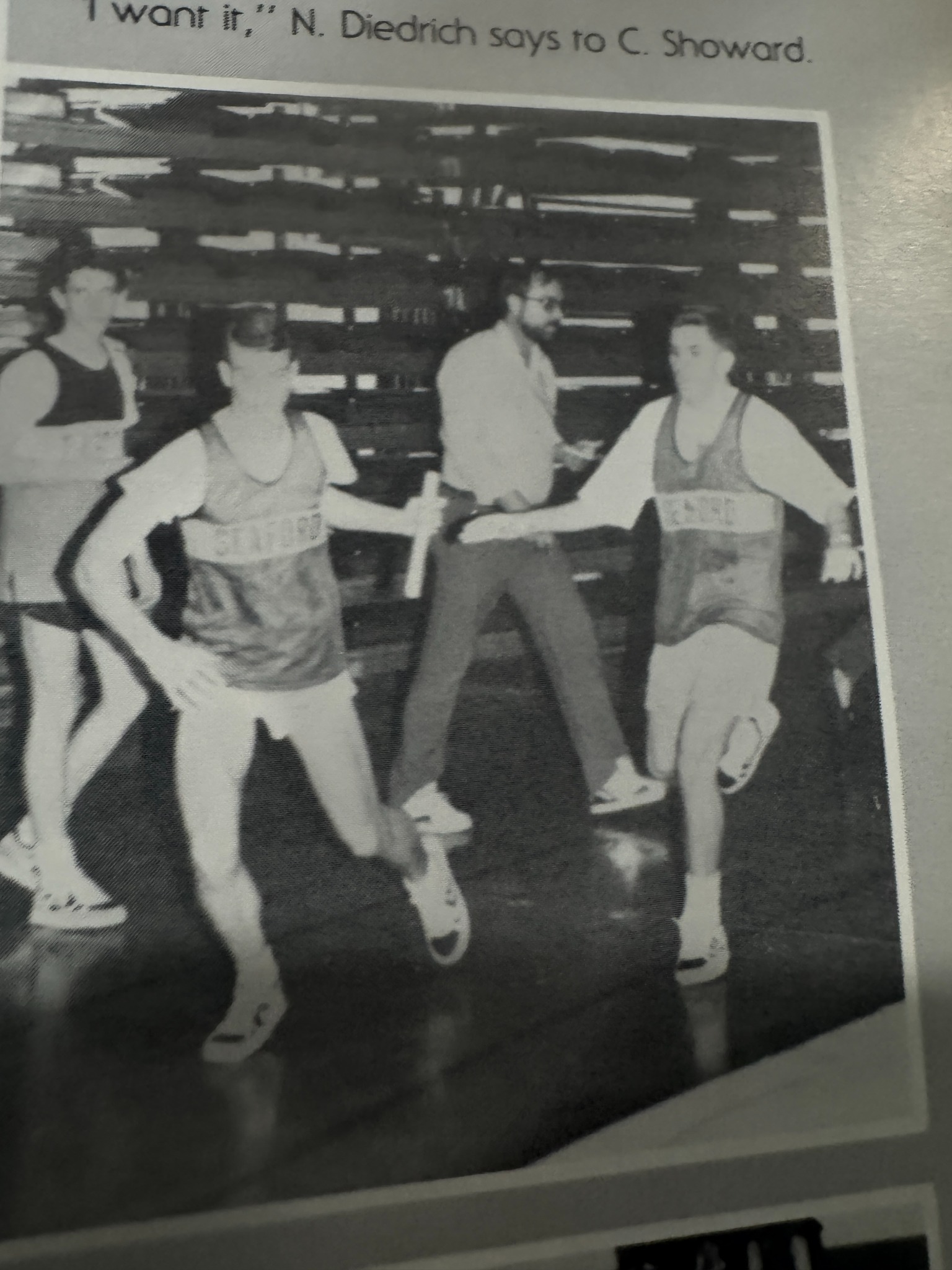 Two Seaford runners exchanging a baton in a yearbook photograph.